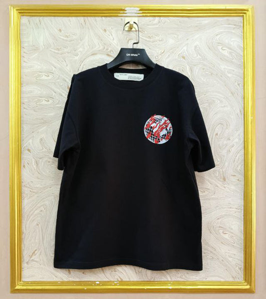 Black t-shirt with "Off-White™" logo on a hanger against a marble wall.