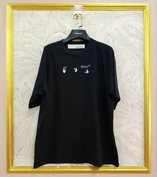 Black t-shirt with "Off-White™" logo on a hanger against a marble wall.