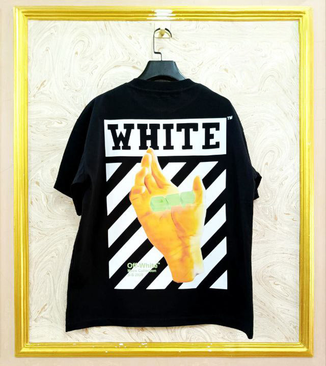 Black t-shirt with "Off-White™" design on a hanger against a decorative wall.