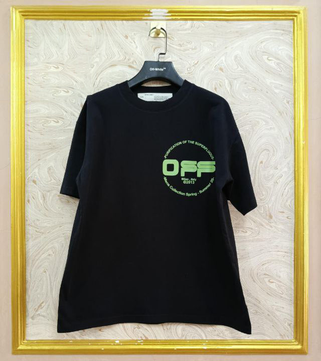 Black t-shirt with "Off-White™" logo on a hanger against a marble wall.