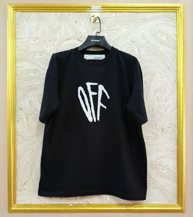 Black t-shirt with "Off-White™" logo on a hanger against a marble wall.