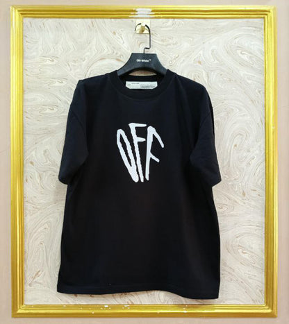 Black t-shirt with "Off-White™" logo on a hanger against a marble wall.