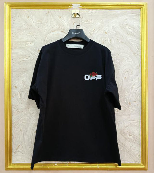Black t-shirt with "Off-White™" logo on a hanger against a marble wall.