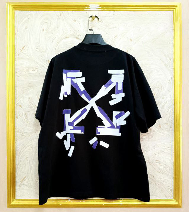 Black t-shirt with "Off-White™" design on a hanger against a decorative wall.