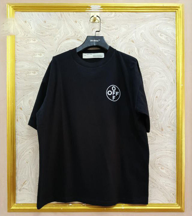 Black t-shirt with "Off-White™" logo on a hanger against a marble wall.