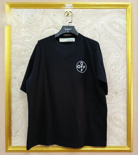 Black t-shirt with "Off-White™" logo on a hanger against a marble wall.