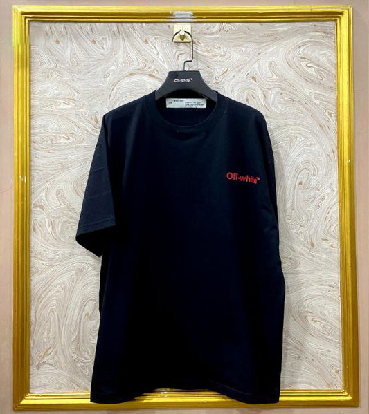 Black t-shirt with "Off-White™" logo on a hanger against a marble wall.