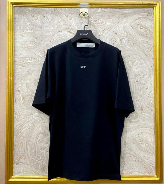 Black t-shirt with "Off-White™" logo on a hanger against a marble wall.