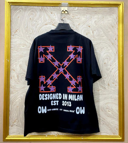 Black t-shirt with "Off-White™" design on a hanger against a decorative wall.