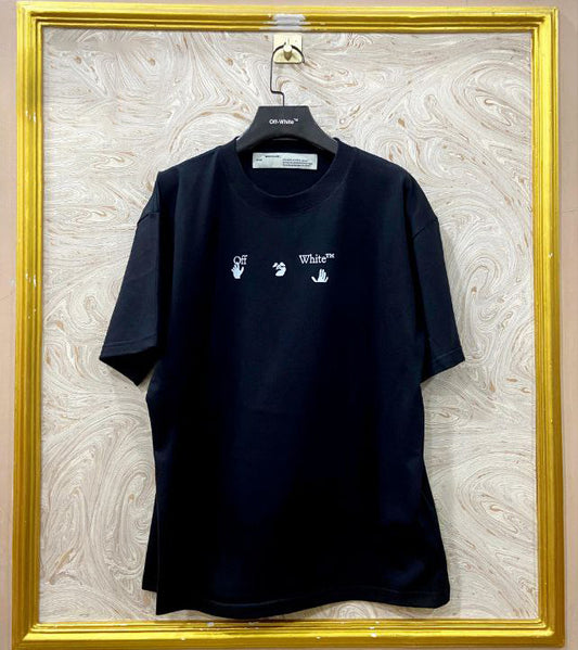 Black t-shirt with "Off-White™" logo on a hanger against a marble wall.