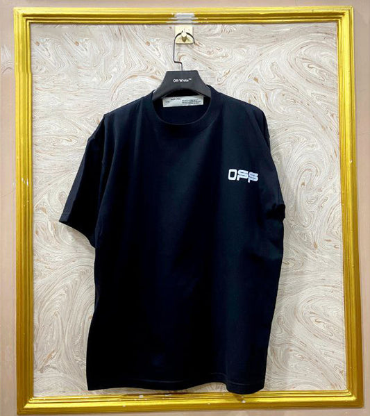 Black t-shirt with "Off-White™" logo on a hanger against a marble wall.