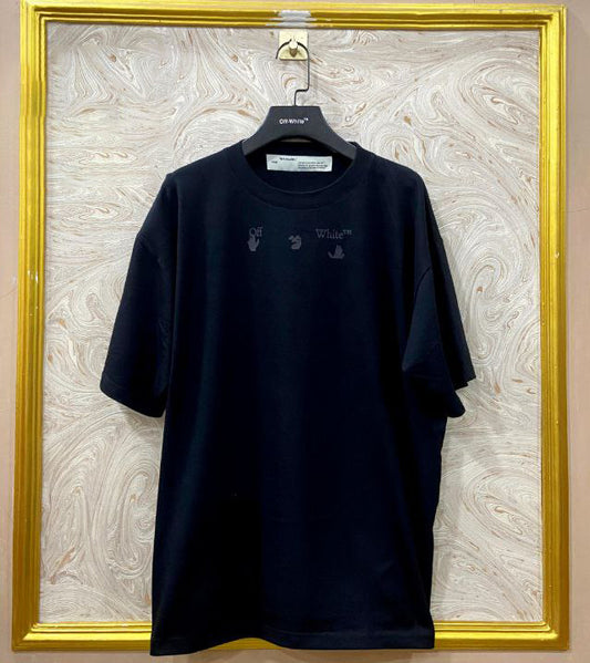 Black t-shirt with "Off-White™" logo on a hanger against a marble wall.
