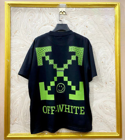 Black t-shirt with "Off-White™" design on a hanger against a decorative wall.
