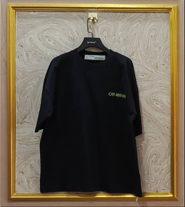 Black t-shirt with 'Off-White' logo on a hanger against a marble wall.