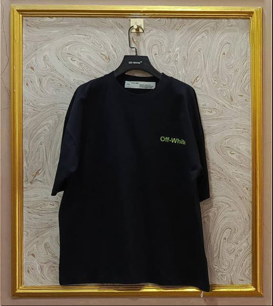 Black t-shirt with 'Off-White' logo on a hanger against a marble wall.