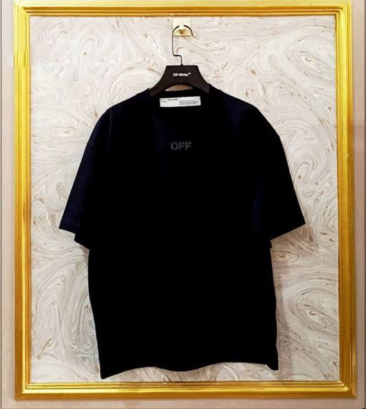 Black t-shirt with 'OFF' logo on a hanger against a marble wall.
