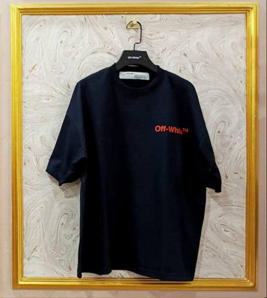 Black t-shirt with red "Off-White™" logo on a hanger against a marble wall.