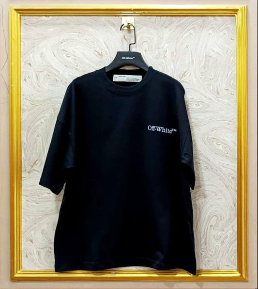 Black t-shirt with white "Off-White™" logo on a hanger against a marble wall.