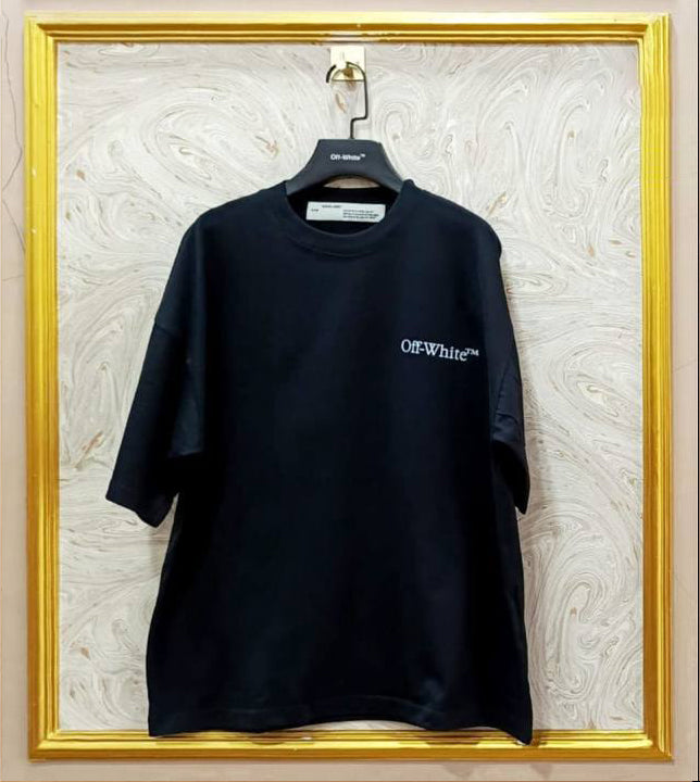 Black t-shirt with 'Off-White' logo on a hanger against a textured wall.