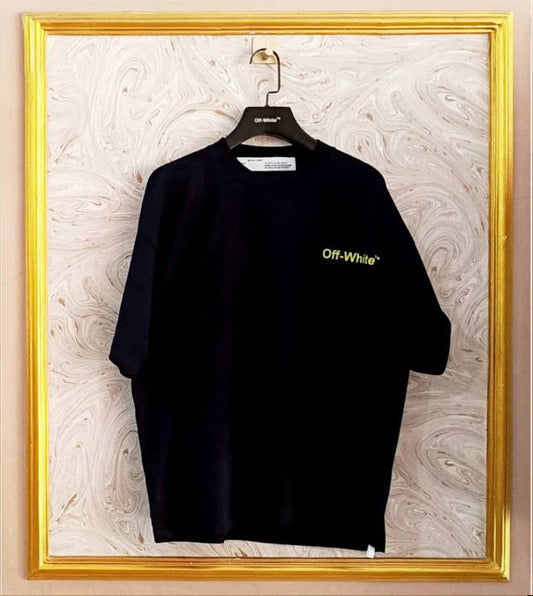 Black Off-White t-shirt on a hanger against a marble wall.