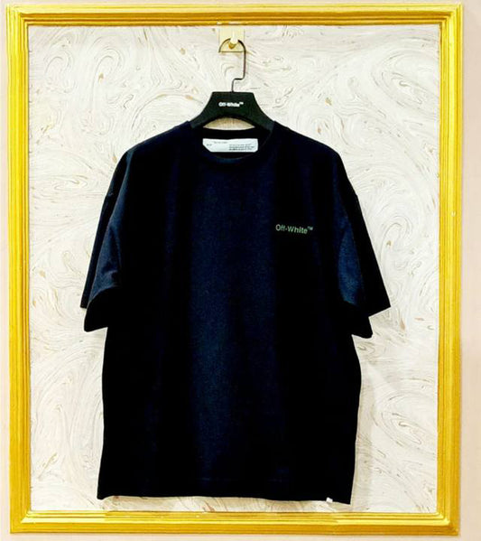 Black t-shirt with "Off-White™" logo on a hanger against a marble wall.