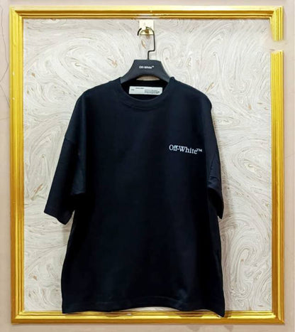 Black t-shirt with "Off-White™" logo on a hanger against a marble wall.