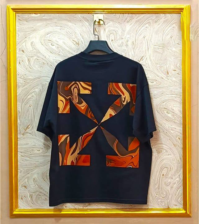 Black t-shirt with flag "Off-White™" design on a hanger against a decorative wall.