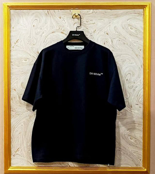 Black t-shirt with "Off-White™" logo on a hanger against a marble wall.