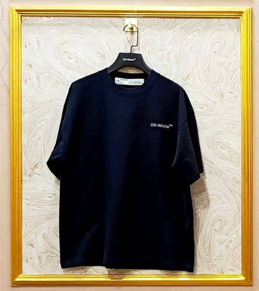 Black t-shirt with "Off-White™" logo on a hanger against a marble wall.
