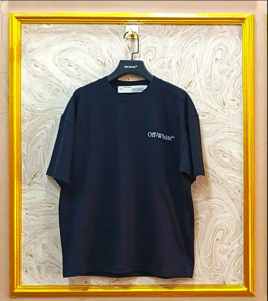 Black t-shirt with "Off-White™" logo on a hanger against a marble wall.