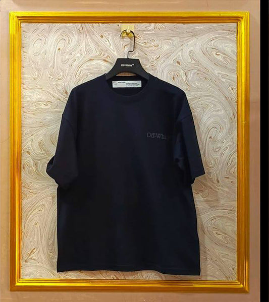 Black t-shirt with "Off-White™" logo on a hanger against a marble wall