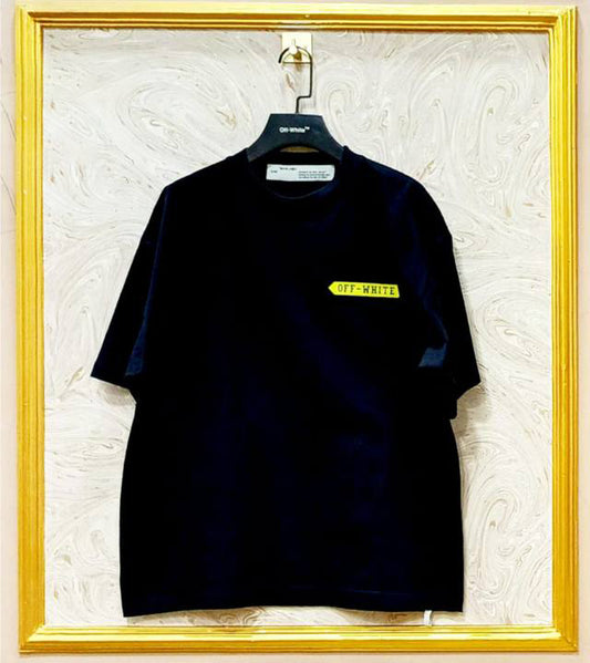 Black t-shirt with "Off-White™" logo on a hanger against a marble wall.