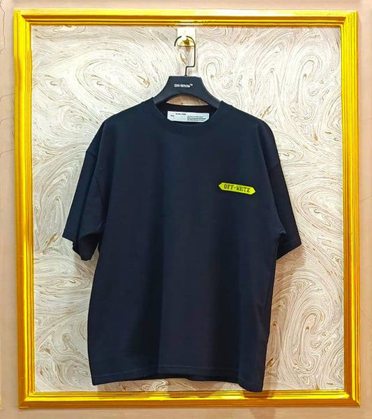 Black t-shirt with "Off-White™" logo on a hanger against a marble wall.
