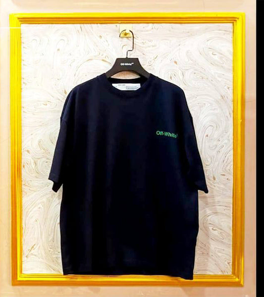 Black t-shirt with "Off-White™" logo on a hanger against a marble wall.