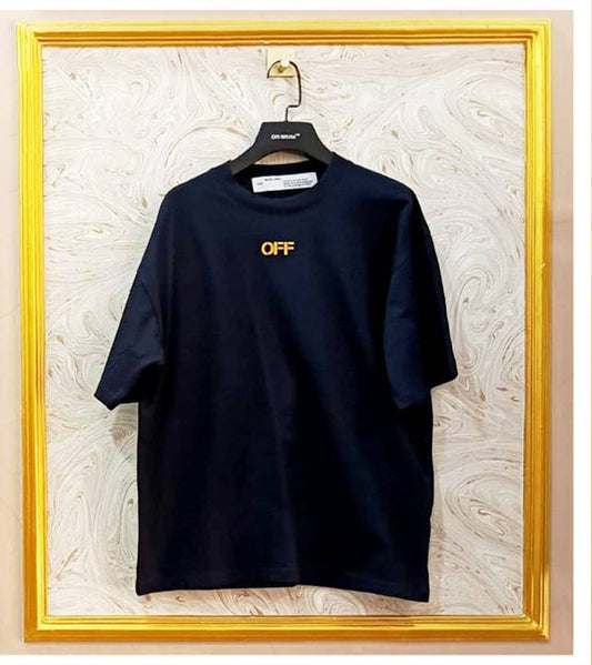 Black t-shirt with "Off-White™" logo on a hanger against a marble wall.