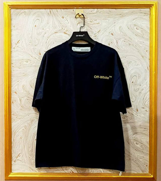 Black t-shirt with "Off-White™" logo on a hanger against a marble wall.