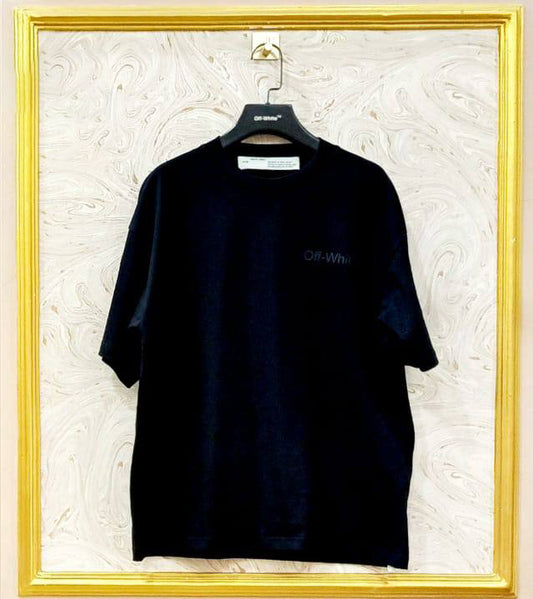 Black t-shirt with "Off-White™" logo on a hanger against a marble wall.