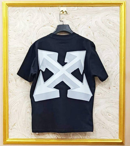 Black t-shirt with "Off-White™" design on a hanger against a decorative wall.
