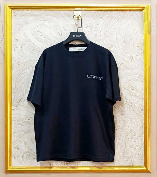 Black t-shirt with "Off-White™" logo on a hanger against a marble wall.