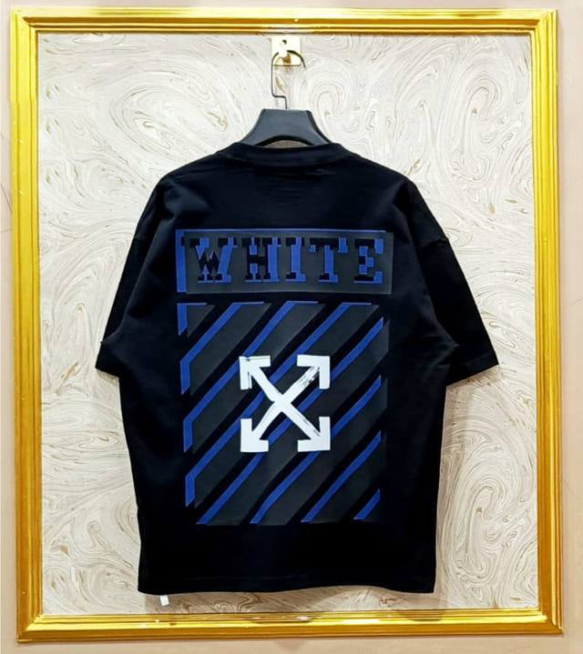 Black t-shirt with "Off-White™" design on a hanger against a decorative wall.
