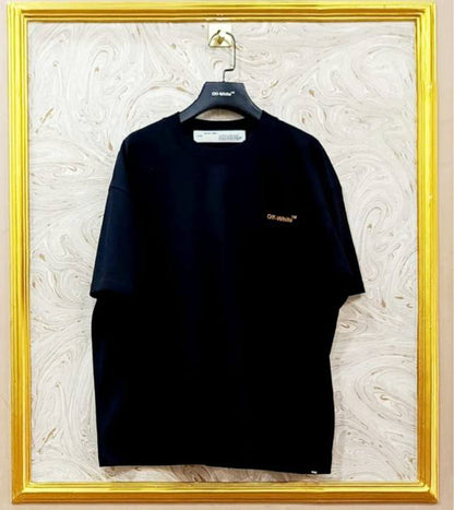 Black t-shirt with "Off-White™" logo on a hanger against a marble wall.