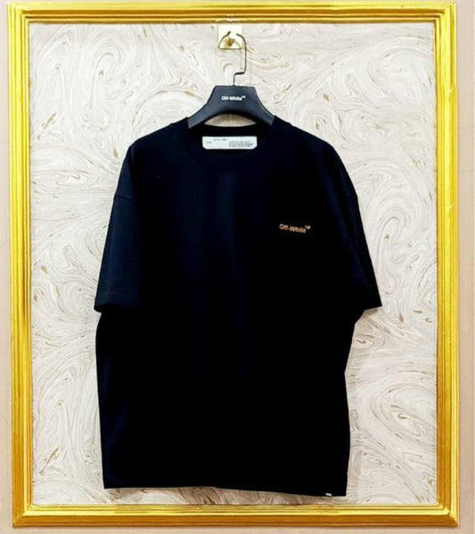 Black t-shirt with "Off-White™" logo on a hanger against a marble wall.