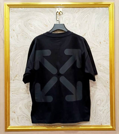 Black t-shirt with "Off-White™" design on a hanger against a decorative wall.