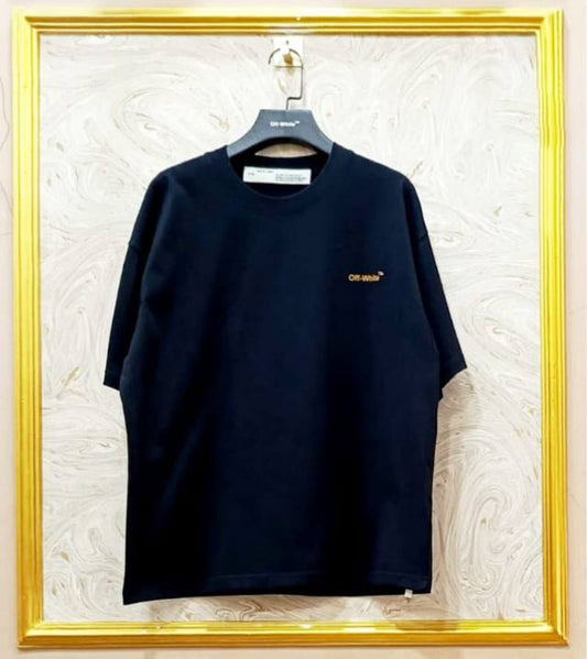 Black t-shirt with "Off-White™" logo on a hanger against a marble wall.