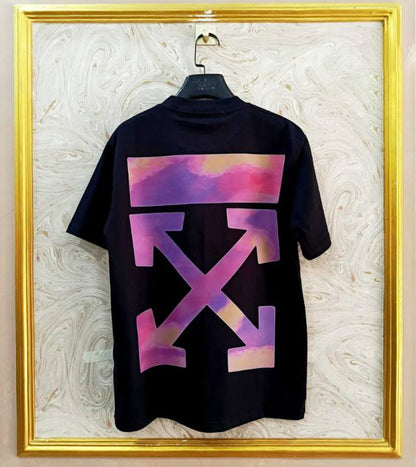 Black t-shirt with "Off-White™" design on a hanger against a decorative wall.