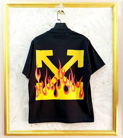 Black t-shirt with "Off-White™" design on a hanger against a decorative wall.