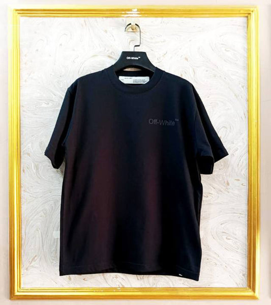 Black t-shirt with "Off-White™" logo on a hanger against a marble wall.