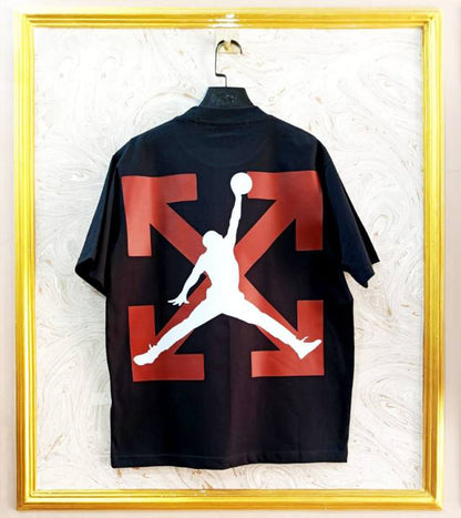 Black t-shirt with "Off-White™" design on a hanger against a decorative wall.