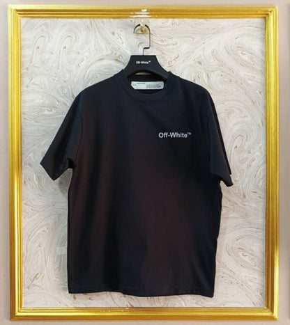 Black t-shirt with "Off-White™" logo on a hanger against a marble wall.