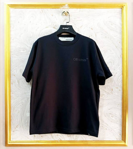Black t-shirt with "Off-White™" logo on a hanger against a marble wall.